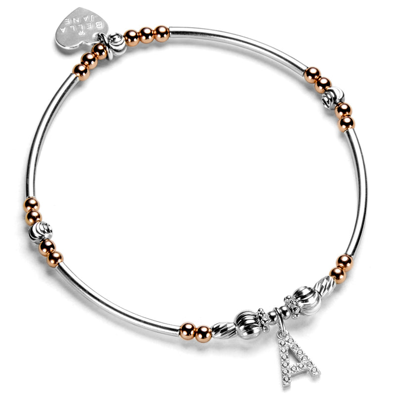 Silver and rose gold beaded bracelet with a sparkly initial A charm on a white background 