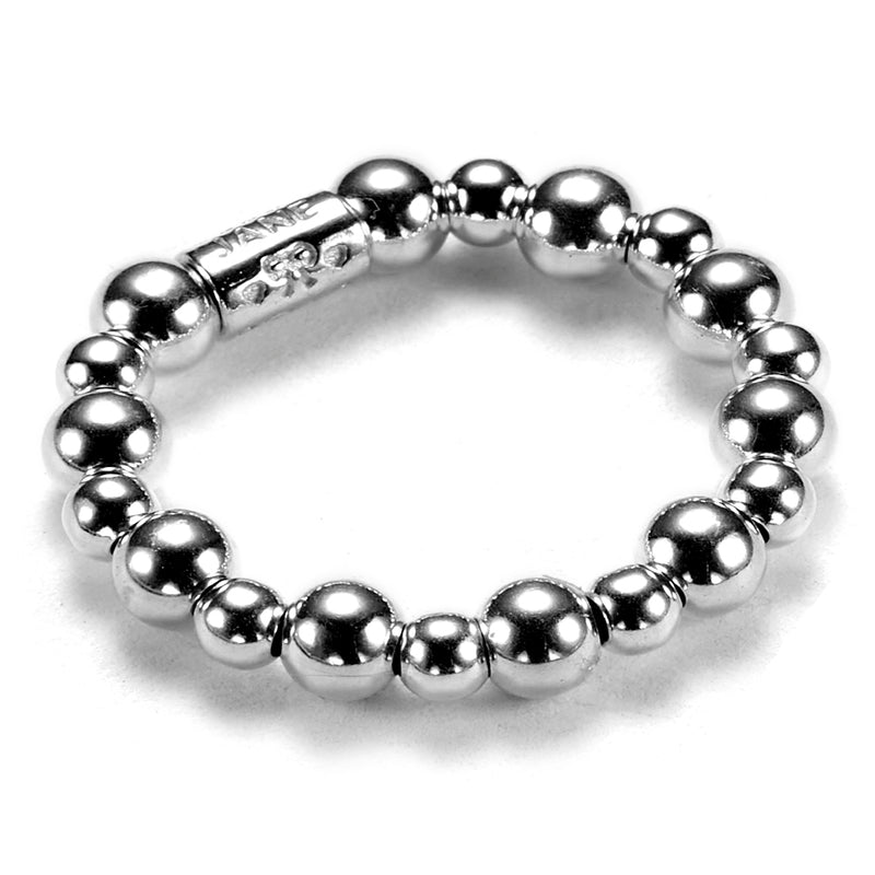 A sterling silver beaded stacking ring with a mix of 4mm and 3mm beads, with a branded Bella Jane tube bead, against a white background