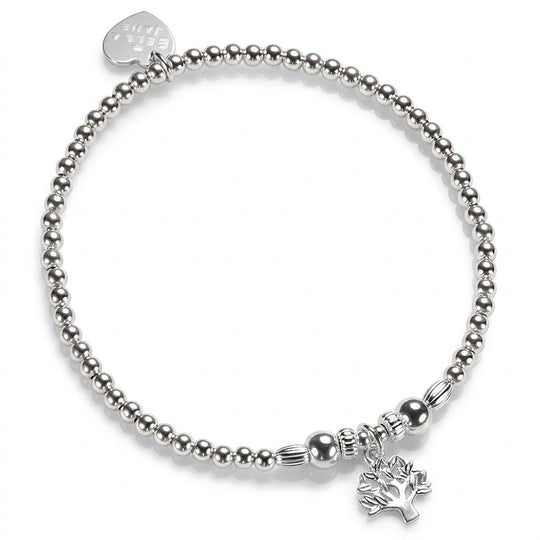 A silver beaded stretch bracelet with a small tree of life charm, with a Bella Jane silver heart tag at the back, against a white background.