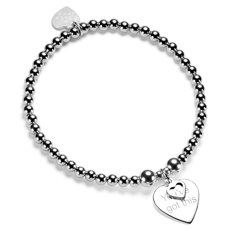 Silver beaded bracelet with a heart-shaped tag with the words 'you've got this' on a white background