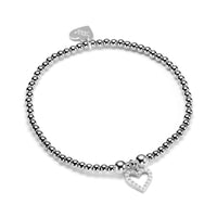 Delicate sterling silver beaded stacking bracelet with open studded heart charm, on a white background