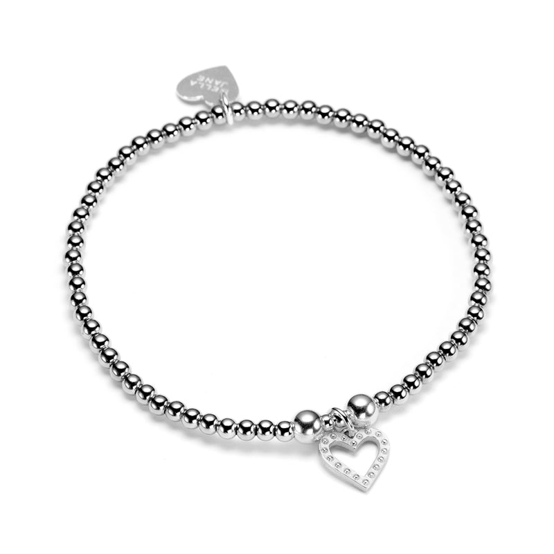 Delicate sterling silver beaded stacking bracelet with open studded heart charm, on a white background
