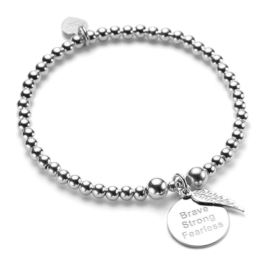 Silver beaded bracelet with a round disc charm with the words Brave, Strong, Fearless engraved on the front, with a tiny angel wing sitting on top of the disc, against a white background.