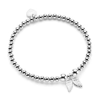 Sterling silver beaded stacking bracelet on a white background featuring a double angel wings charm