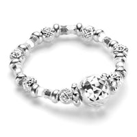 A sterling silver ring with beaded detailing and a diamond cut central bead