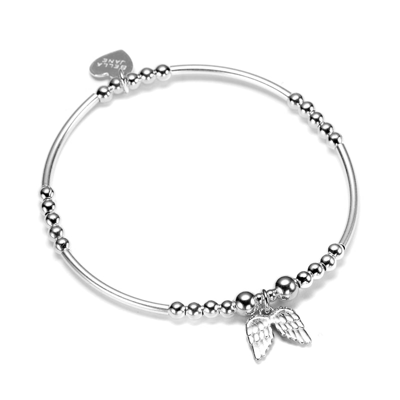 A sterling silver bracelet featuring small round beads with noodle shaped beads and a charm in the shape of angel wings, along with a small Bella Jane branded heart tag, displayed on a white background.