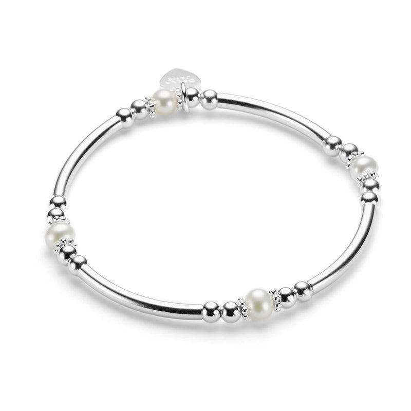 A sterling silver bracelet featuring freshwater pearls and a heart tag, displayed against a white background.