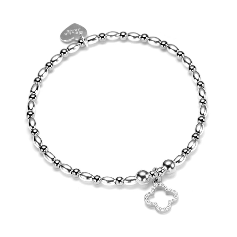 Sterling silver beaded Fortuna stacking bracelet with clover charm and Bella Jane branded heart tag, against a white background