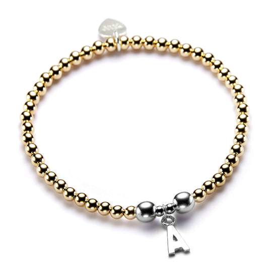Gold-filled and sterling silver beaded stacking bracelet with a sterling silver initial 'A' charm, on a white background