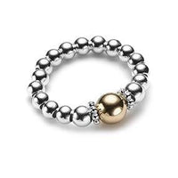Silver beaded ring with a gold focal bead, on a white background
