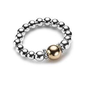 Silver beaded ring with a gold focal bead, on a white background