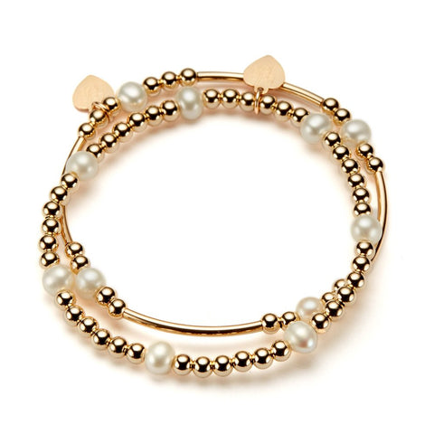 Two gold and pearl beaded bracelets on a white background