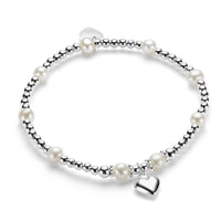 A sterling silver bracelet with freshwater pearls and a silver heart charm, displayed against a white background.