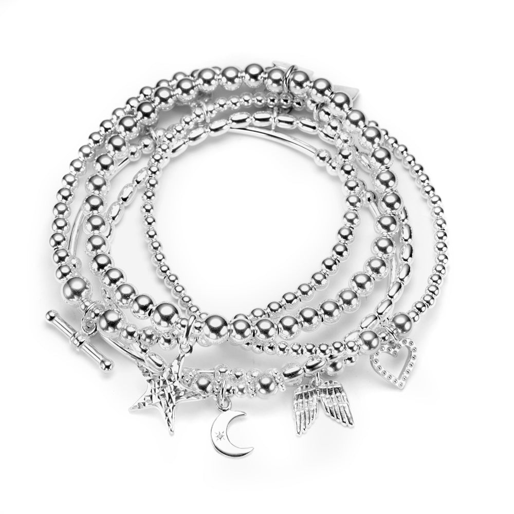 A stack of five sterling silver bracelets with various charms, including a star, heart, t-bar, moon and angel wings, displayed on a white background.