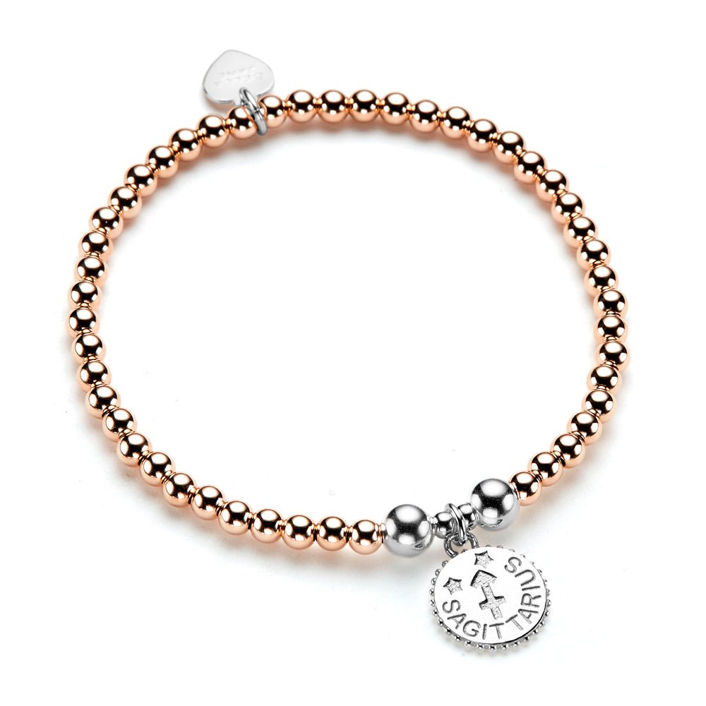 Rose gold and sterling silver beaded bracelet with a sterling silver round disc charm with the Sagittarius zodiac sign, on a white background