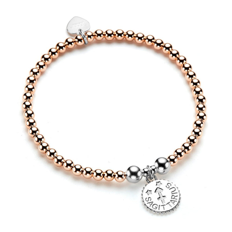 Rose gold and sterling silver beaded bracelet with a sterling silver round disc charm with the Sagittarius zodiac sign, on a white background