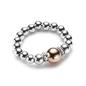 Silver beaded stacking ring with a rose gold focal bead on a white background
