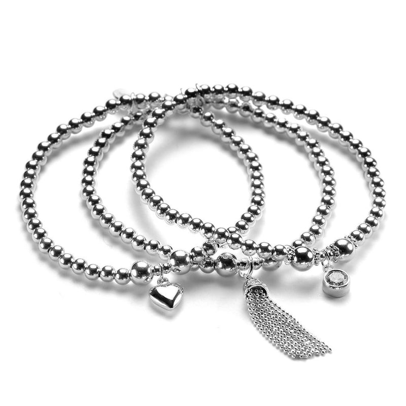 Three sterling silver beaded bracelets with charms, including a small heart, a tassel, and a sparkly cubic zirconia, displayed on a white background.