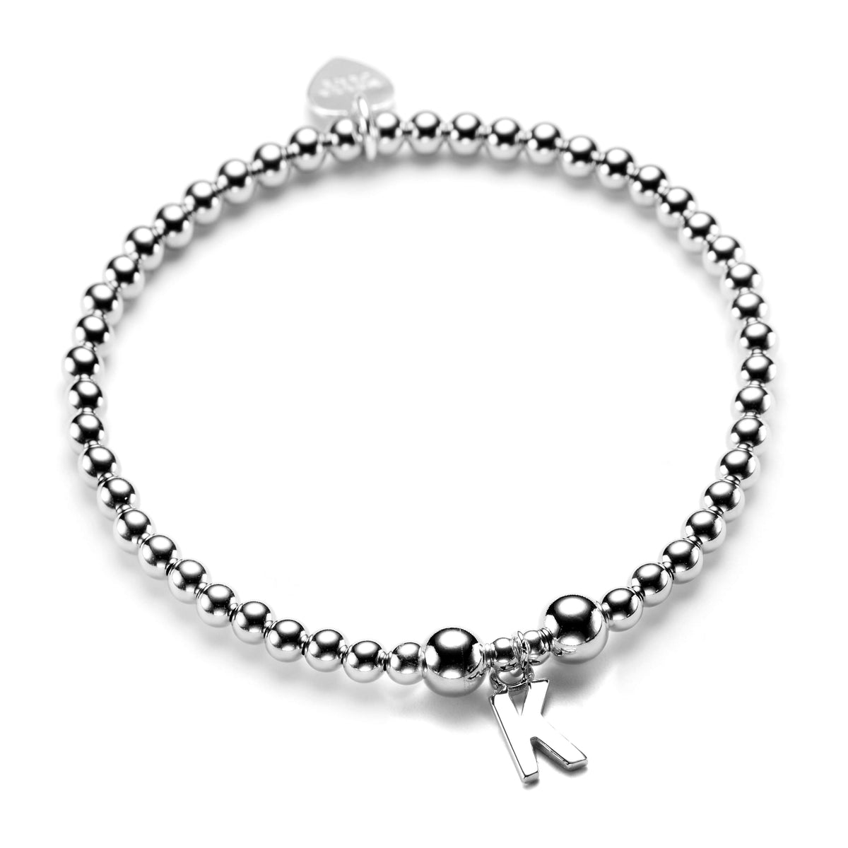 A close up or a sterling silver beaded stacking bracelet with a silver initial charm