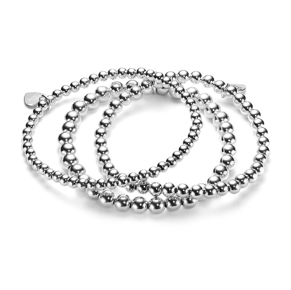 A stack of three plain beaded sterling silver stacking bracelets with beads of different sizes, displayed on a white background.