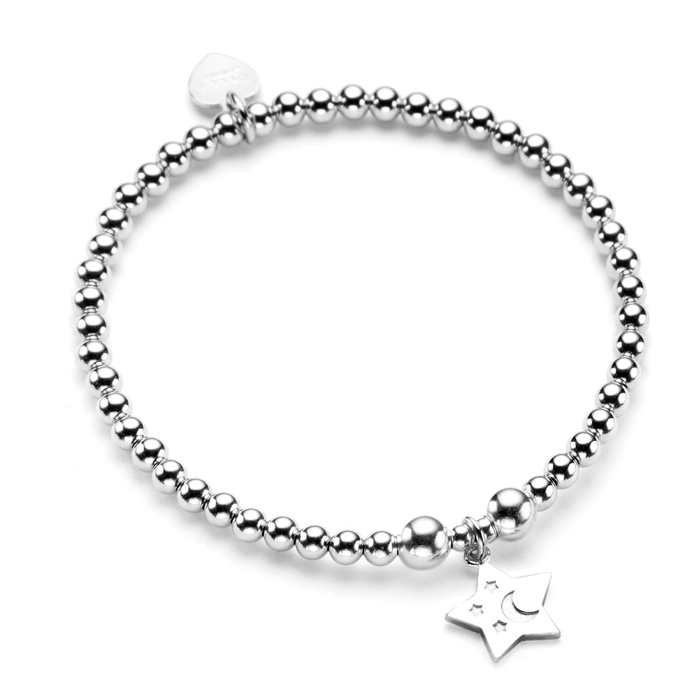 A sterling silver bracelet featuring 4mm round beads and a star charm with embossed tiny stars and moon, displayed against a white background.