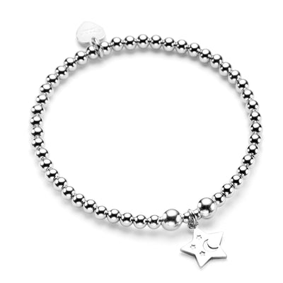A sterling silver bracelet featuring 4mm round beads and a star charm with embossed tiny stars and moon, displayed against a white background.